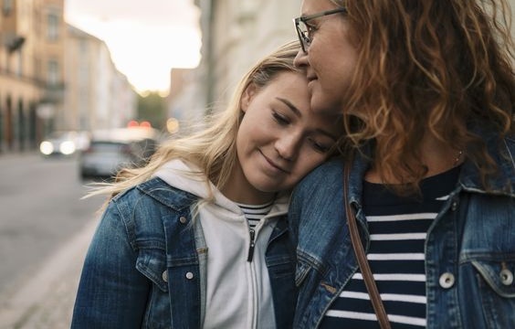 Smiling Mother And Daughter In City